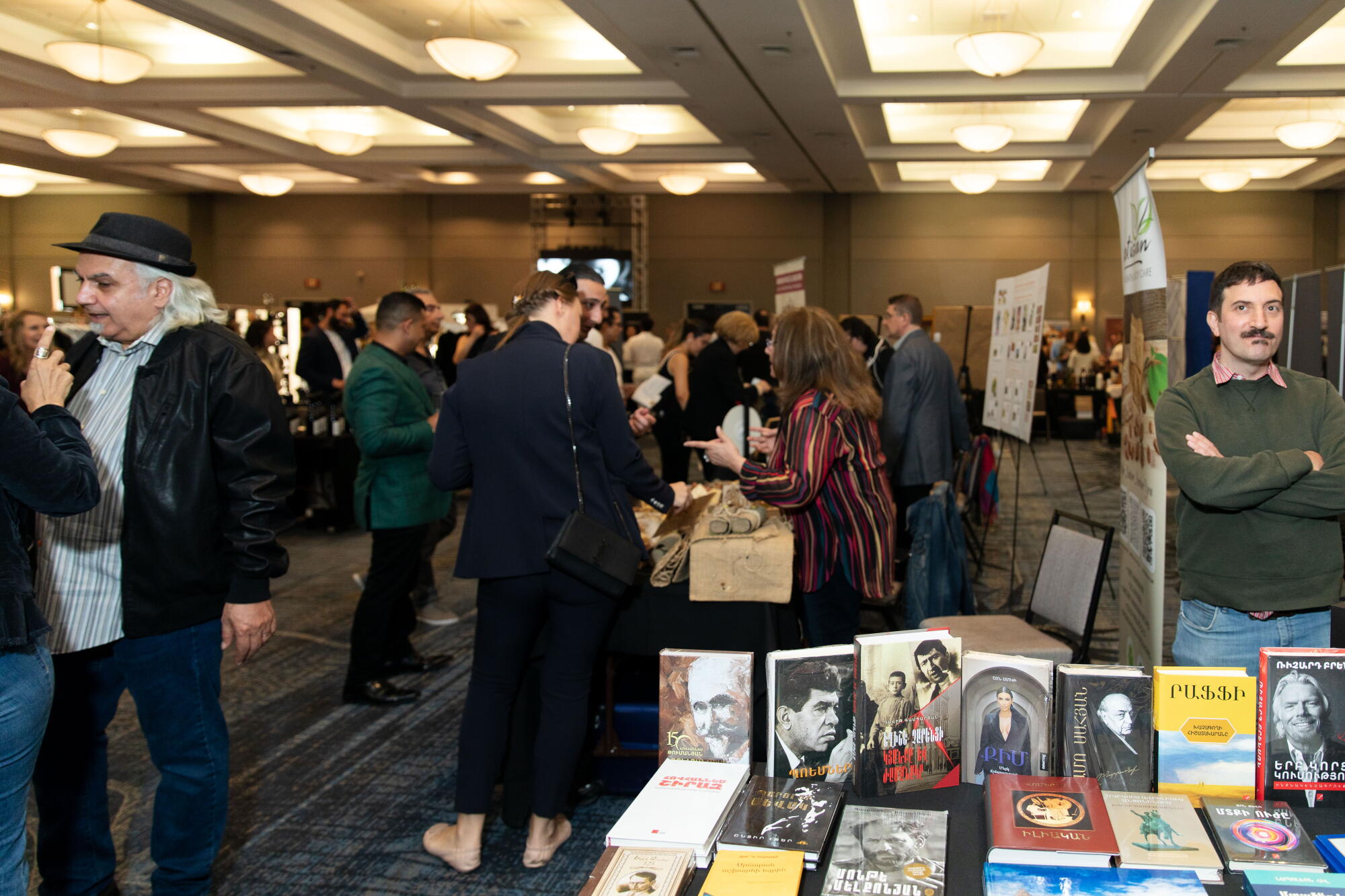 Guests mingling among the booths at GiniFest 2023 in Burbank